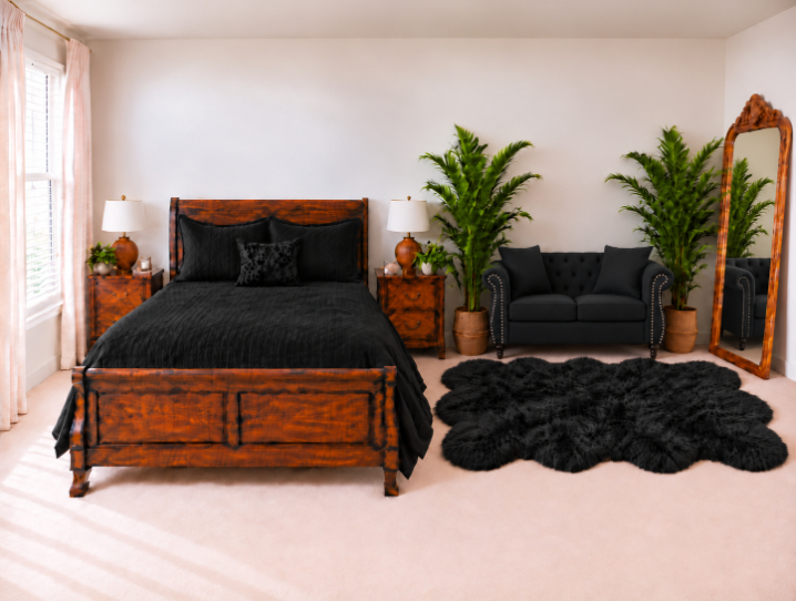 A bedroom featuring a dark wood bed frame and two matching nightstands with lamps, a black tufted loveseat, two potted plants, a full-length floor mirror, and a black faux-fur rug on a light carpeted floor.